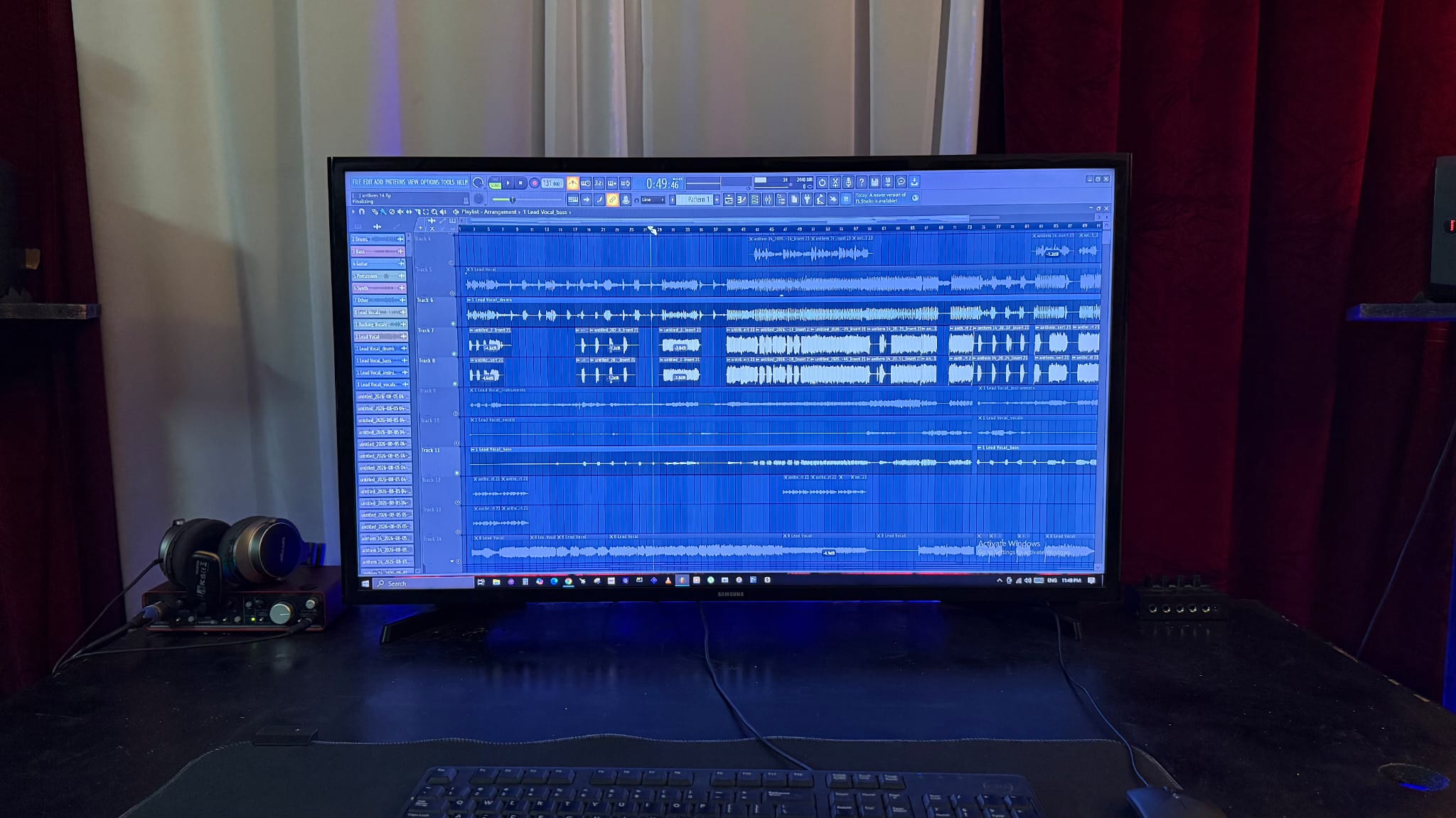 Producer desk with studio monitors, headphones and a DAW arrangement on screen