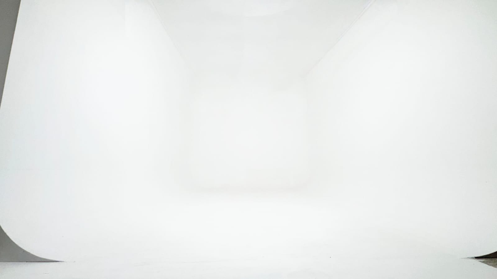 Seamless white infinity cove at Jazba Studios, the wall curving into the floor